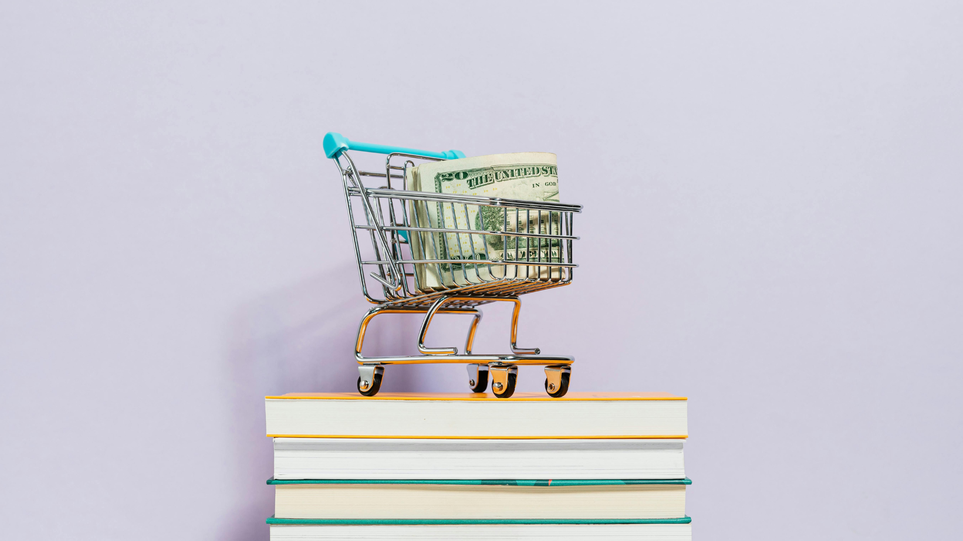 A tiny model grocery cart holds cash in its basket, suggesting that it is grocery money, which is what programs like SNAP provide.